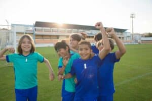 Kids celebrating playing soccer because it's fun